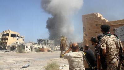 Libyan forces allied with the UN-backed government take cover during a battle with ISIL in Sirte on October 2, 2016. Hani Amara / Reuters