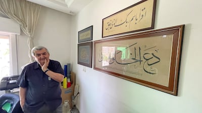Mr Tabbal stands next to works that were gifted to him by the late Iraqi calligrapher Abbas Al Baghdadi