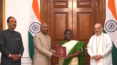 India's former president Ram Nath Kovind hands over his committee's elections report to President Droupadi Murmu. Photo: President of India
