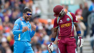 The left-arm spinner took his fifth wicket when he clean-bowled Ravi Rampaul. Darren Sammy, right, is seen at the non-striker's end. Matt Dunham / AP Photo