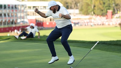 Shane Lowry of Team Europe celebrates as he sinks the putt that secured the Ryder Cup on the 18th green. AFP