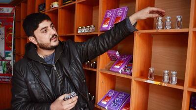 An Afghan saffron shop keeper arranges items at his shop in Herat, Afghanistan.
