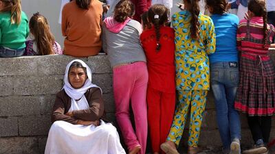 Iraqis are seen at Bajid Kandala camp for internally displaced people, west of the Iraqi Kurdish city of Dohuk. Safin Haned / AFP