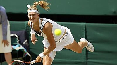 Petra Kvitova serves to Maria Sharapova during her 6-3, 6-4 victory to clinch the women's singles title at Wimbledon.