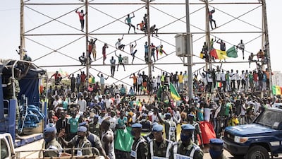 Supporters cheers ahead of the Senegalese football team's arrival in Dakar on Monday, January 7, 2022, after winning the Africa Cup of Nations. AFP