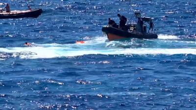 The migrants in their orange lifejackets are rescued. AFP PHOTO / LOCAL TEAM