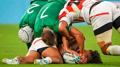 Japan's full back Ryohei Yamanaka (on the ground) is stopped by Ireland's hooker Rory Best (L) and Ireland's flanker Josh van der Flier (C) as Japan's back row Michael Leitch (R) pushes in during the Japan 2019 Rugby World Cup Pool A match between Japan and Ireland at the Shizuoka Stadium Ecopa in Shizuoka. AFP