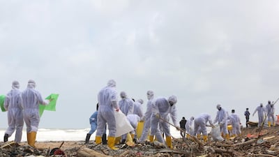 Clean-up teams clear debris from the fire-ravaged 'MV X-Press Pearl'. EPA