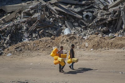 Displaced Palestinians with empty water containers in central Khan Younis, Gaza, on Tuesday, May 7, 2024. Bloomberg