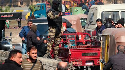A riot policeman stands guard by the barriers that block the site of the protests during an ongoing anti-government demonstration in Baghdad. AP Photo