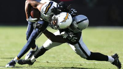 Oakland Raiders cornerback D.J. Hayden tackles San Diego Chargers wide receiver Travis Benjamin during the second half of their NFL game at the Oakland-Alameda County Coliseum in Oakland, California. John g Mabanglo / EPA