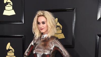 All the dresses in the world, and Katy Perry chooses this one. We could probably live with the blah-coloured feather skirt, and maybe even the long-sleeved sequin top … if only either fit her properly. Kevin Mazur / Wire Image