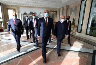 Tunisian Prime Minister Hichem Mechichi (C) with Parliament Speaker Rached Ghannouchi (R) arrive during a parliamentary session to vote on the finance law for the 2021 financial year at the Assembly of the People's Representatives (ARP) in Tunis, Tunisia, 28 November 2020. EPA