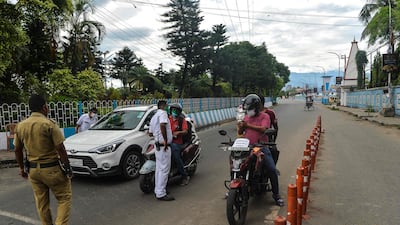 Police check vehicles at a checkpoint during a 15-day partial lockdown, with travel restrictions, imposed to curb the spread of Covid-19 in Siliguri, north-east India. AFP