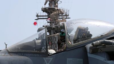 A US Marine maintains an AV-8B Harrier aircraft.