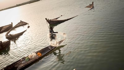 A fisherman throws a net in the River Niger in Bamako, Mali. AFP