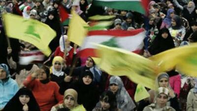 Hizbollah supporters wave Hizbollah, Palestinian and Lebanese flags during a rally in a southern suburb of Beirut.