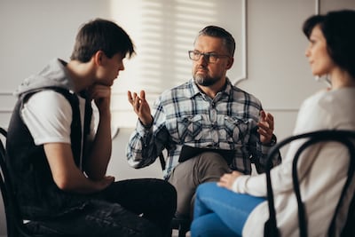While parents should be present during a family therapy session, they should let their adult children lead the discussion to air their grievances. Getty Images
