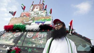 Ahmad Issa, from Pakistan, poses in front of his decorated car as he celebrates the 41st UAE National Day during the Union Car Parade on Yas Island, Abu Dhabi. Silvia Razgova / The National