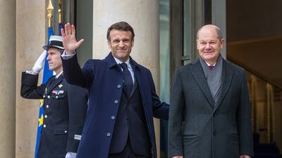 French President Emmanuel Macron, left, welcomes German Chancellor Olaf Scholz to the Elysee Palace in Paris on Sunday. EPA