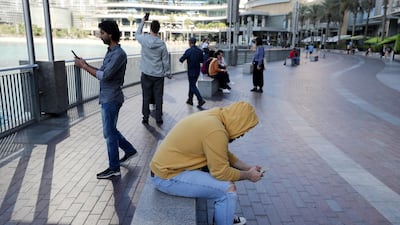 Residents wore hoodies on their way to work on Sunday morning. Chris Whiteoak / The National