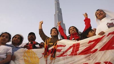Nasr Al Neyadi, in red, cheers with supporters after free-falling from the Burj Khalifa in 2010. The divers made the jump after the inauguration of the building, covering a descent of 672 metres.
