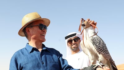 A falcon perches on the arm of South Korean President Moon Jae-in during his visit to a desert near Abu Dhabi.. EPA / Yonhap