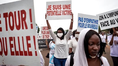 A protester holds a placard reading "I am a potential victim" in Bamako, during a demonstration against violence against women in Mali, a few days after the arrest of famous kora player Sidiki Diabate for the alleged beating and kidnapping of his girlfriend. AFP