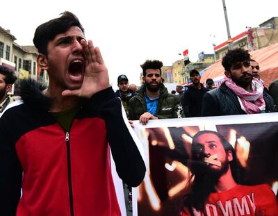 Iraqi protesters chant slogans as they carry the picture of a protester who was kidnapped by unknown gunmen during a protest at the Al Tahrir square in central Baghdad, Iraq, 16 January 2020. EPA