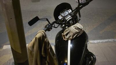 Tools of the trade. A suit jacket, leather gloves and vintage styled helmet rests on it’s owners vintage styled Triumph scrambler at the end of the 2014 Distinguished Gentleman’s Ride in Dubai.