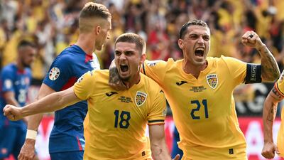 Romania's Razvan Marin, left, celebrates with teammate Nicolae Stanciu after scoring. AFP