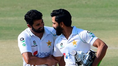 Pakistan's Fawad Alam, right, and Azhar Ali celebrate their victory on the fourth day of the first Test against South Africa at the National Stadium in Karachi on Friday. AFP