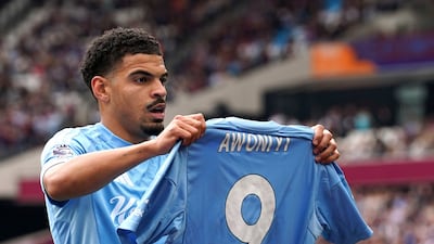 Nottingham Forest's Morgan Gibbs-White holds up a tribute to teammate Taiwo Awoniyi. PA
