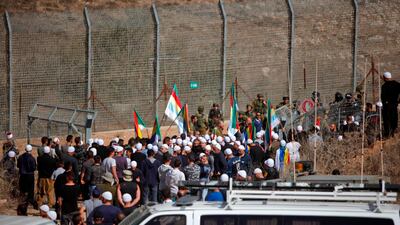 Members of Israel's Druze community gather at the fence separating the Israeli-held and Syrian sides of the Golan Heights on November 3, 2017 after hearing about an attack on the Syrian Druze village of Hader by extremist rebels. Jalaa Marey / AFP