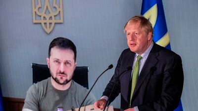 British Prime Minister Boris Johnson speaks in front of a live video feed showing Ukrainian President Volodymyr Zelenskyy at the Tate Modern in London. Getty Images