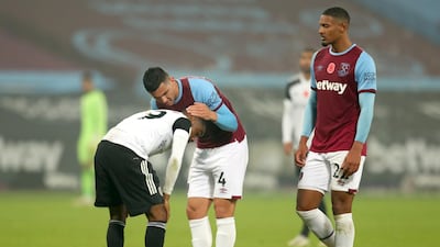 Fulham's Ademola Lookman (left) is consoled by West Ham United's Fabian Balbuena. PA