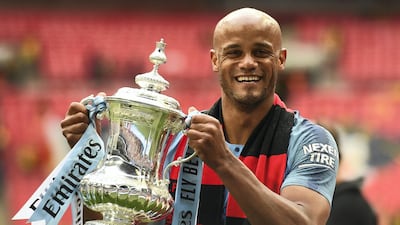 Vincent Kompany holds the winner's trophy after the FA Cup win against Watford in 2019, his last game for Manchester City. AFP