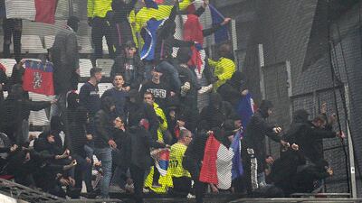 Lyon fans trying to break the net on the stands prior to the match against Lyon at Stade Velodrome. AP