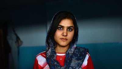 An Afghanistan national powerlifting team member poses after training.