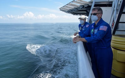 Nasa Chief Astronaut Pat Forrester, left, and Nasa astronaut and Crew Recovery Chief Shane Kimbrough, along with other Nasa and SpaceX support teams onboard the SpaceX GO Navigator recovery ship AP
