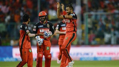 Royal Challengers Bangalore bowler Yuzvendra Chahal (L) celebrates the wicket of Sunrisers Hyderabad Deepak Hooda (unseen) with his team mates, during the 2016 Indian Premier League(IPL) Twenty20 cricket match between Royal Challengers Bangalore and Sunrisers Hyderabad at The M Chinnaswamy Stadium in Bangalore on April 12, 2016. AFP / MANJUNATH KIRAN