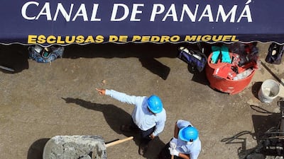 A group of men work on the maintenance of the dry chamber of the Miraflores lock at Panama Canal. Alejandro Bolivar / EPA