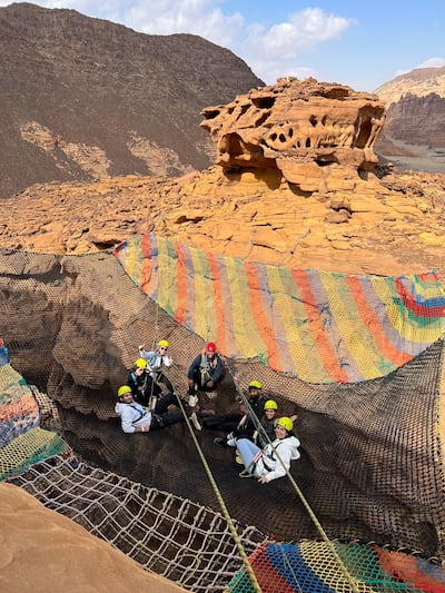 Tourists rock climbing in AlUla