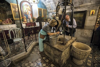 American Christian pilgrims at Jacob's Well in St Photini's Church in the Balata refugee camp beside the West Bank city of Nablus. Heidi Levine for The National
