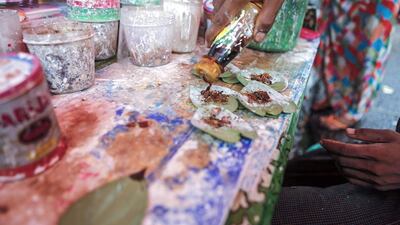 A street vendor adds tobacco liquid onto betel quids in Yangon, Myanmar. Lynn Bo Bo / EPA