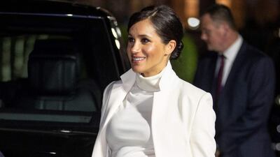 Meghan, Duchess of Sussex, wears a Calvin Klein dress and Amanda Wakeley coat at a gala performance of 'The Wider Earth' at the Natural History Museum in London on February 12, 2019. AFP