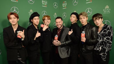 Mo' Bounce, centre, poses for a photo with Monster X members I.M, Jooheon, Kihyun, Hyungwon, Shownu, and Minhyuk. Getty