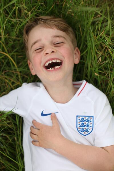 A laughing Prince George, showing his love for football, in a new photo released to celebrate his sixth birthday. The Duchess of Cambridge via Getty Images