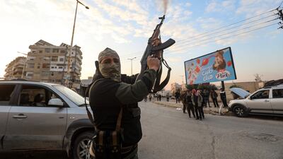A Syrian anti-government fighter shoots into the air after rebels seized control of the city of Hama. AFP