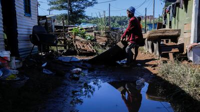 People drag a carpet outside to dry after their home in Durban was flooded. Reuters